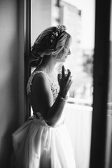 Bride applying perfume on her neck. Wedding day.