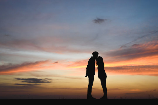 Silhouette of couple kissing at the sunset