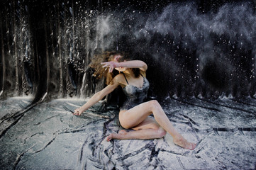 Girl dancer jumping and dancing in the white dust with flour on © AS Photo Family