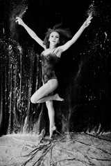 Girl dancer jumping and dancing in the white dust with flour on © AS Photo Family