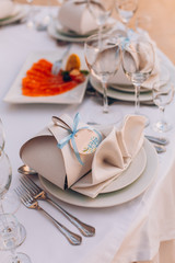 Table set for wedding or another catered event dinner. Decoration arch flowers gift box.
