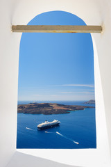 View through church window in Fira to caldera sea, Santorini