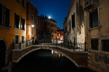 Night view of typical canal in Venice, Italy.