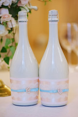 Two decorated bottles of champagne on the wedding celebration
