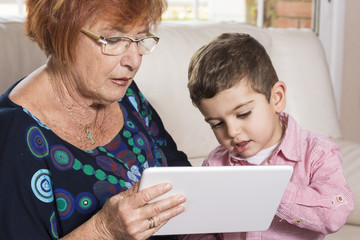 Grandma and grandson looking at tablet computer together