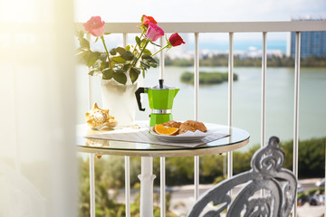 Breakfast with coffee on terrace decorated with flowers