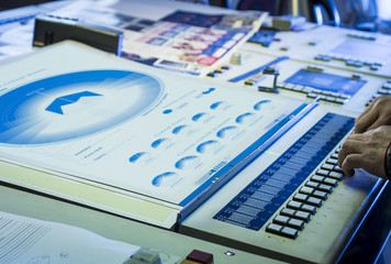 Young man in the process of offset printing and color correction