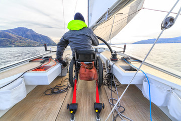 disabled man with wheelchair on sailing boat