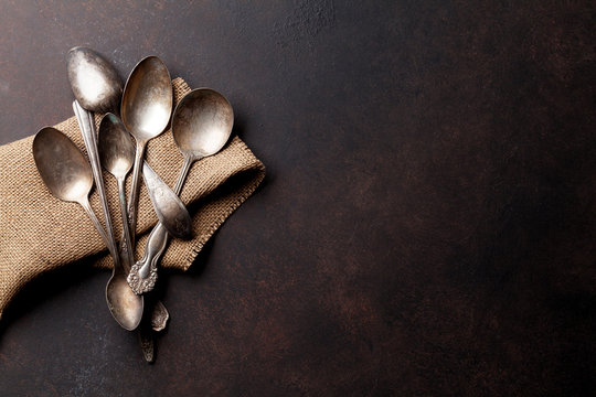 Old vintage spoons on stone table