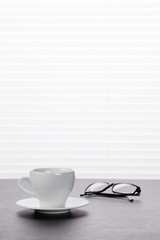 Office workplace with coffee and glasses