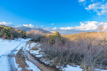 Snowy road blue clouds sky