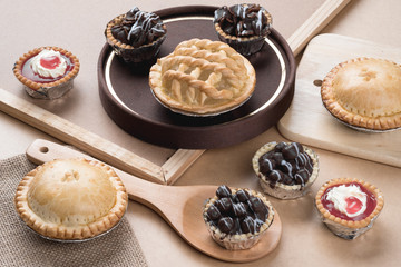 Coconut pie and chocolate mini tart on wooden background
