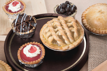 Coconut pie and chocolate mini tart on wooden background