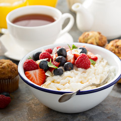 Rice pudding with fresh berries and coconut for breakfast