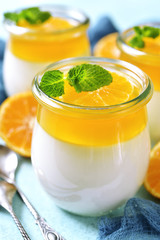 Panna cotta with orange jelly in a vintage jar,traditional itali