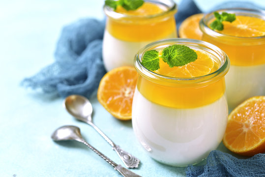 Panna cotta with orange jelly in a vintage jar,traditional itali