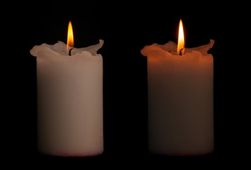 Two candles isolated on dark background with clipping path.