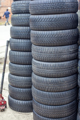 Obraz premium used car tires pile in the tire repair shop yard