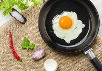 Morning in the kitchen. Cooking breakfast. Fried egg.