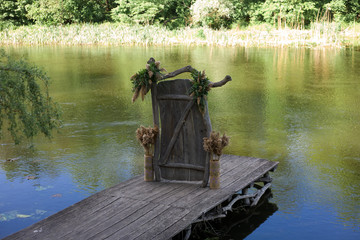 Fototapeta na wymiar decorative wooden door on a pier near the river