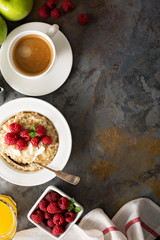 Obraz na płótnie Canvas Steel cut oatmeal porridge with raspberry and coconut