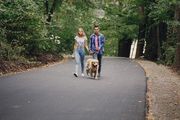 couple walking outdoors with her dog