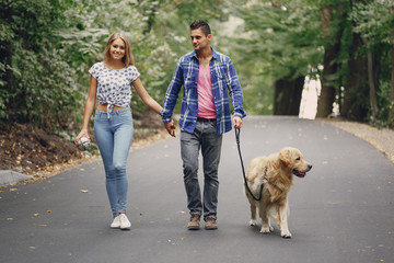 couple walking outdoors with her dog