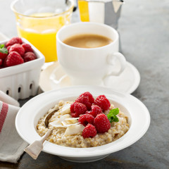 Steel cut oatmeal porridge with raspberry and coconut