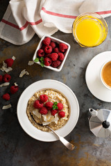 Steel cut oatmeal porridge with raspberry and coconut