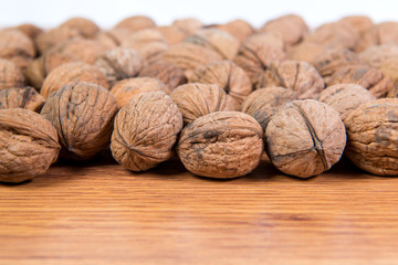 A lot of scattered walnuts close-up. A useful product.