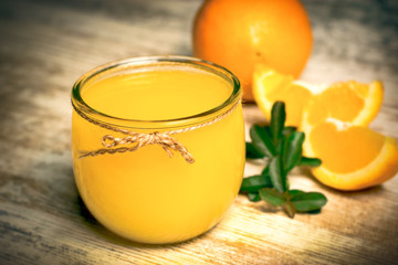 Orange juice on rustic table - freshly squeezed orange juice