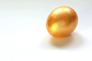 Big Golden chicken egg on white background