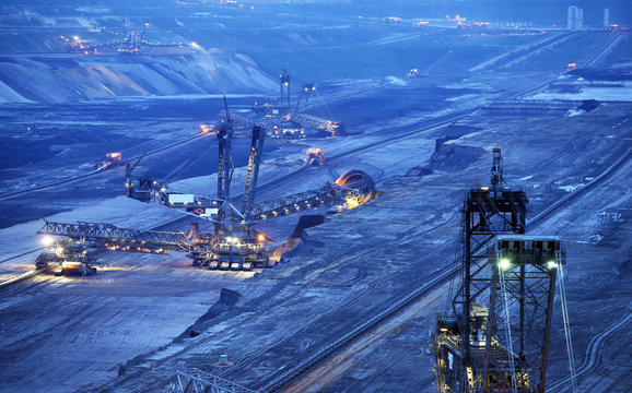 Large bucket wheel excavators in a lignite (brown-coal) mine after sunset, Germany
