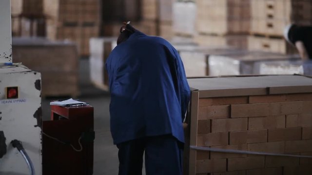 A woman working at the plant packs polyethylene refractory bricks.