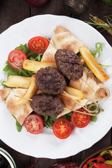 Kofta kebab with fried potatoes