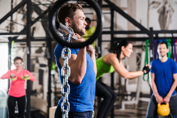 Man lifting dumbbell in functional training gym session