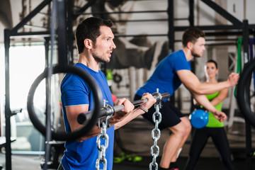 Man lifting dumbbell in functional training gym session