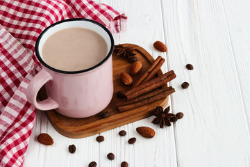 A cup of  hot chocolate with coffee beans,almond, cinnamon and