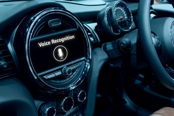 Voice recognition , speech talk and internet of things (iots) in smart car concept. Car 's console show application display and microphone icon.