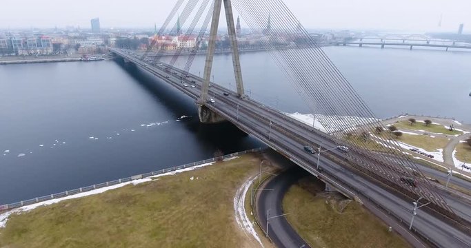 4K Aerial winter view of cable-stayed bridge over Daugava river in Riga Latvia. Vansu Bridge.