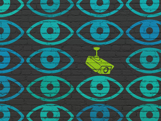 Safety concept: cctv camera icon on wall background