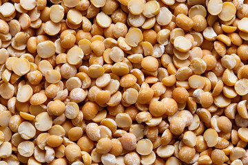 Background of yellow dried split peas from above.