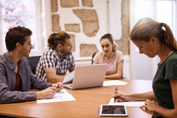 Four millenials in a strategic meeting