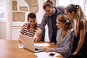 Young business team sharing a laptop