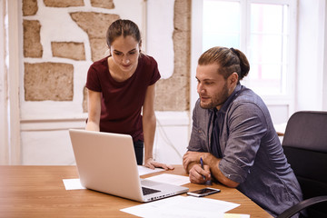 Young business woman instructing young man