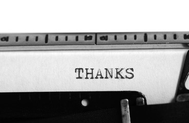 Typewriter. Typing text: thanks