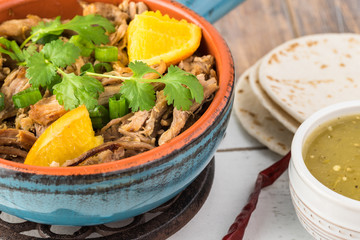 Mexican food. Slow cooked pork carnitas with salsa verde