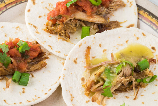 Mexican food. Slow cooked pork carnitas with salsa verde