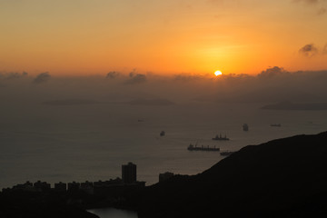 Naklejka premium Ocean, islands, ships, coastline and sunset in Hong Kong, China, viewed from the Victoria Peak. Copy space.