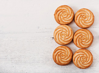 Tasty baked cookies on old wooden background, top view.